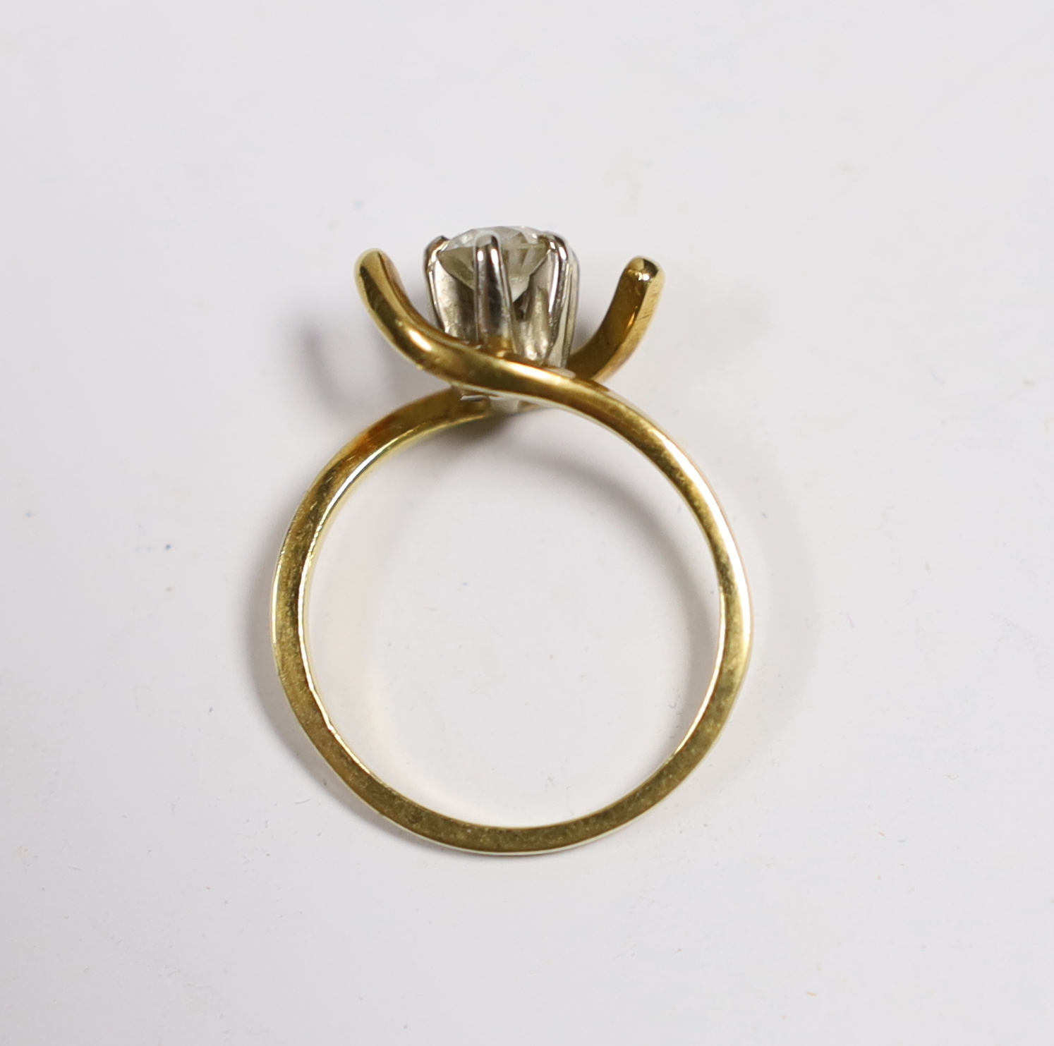 A yellow metal and solitaire diamond set ring, with crossover shoulders, size M, gross weight 3.5 grams.